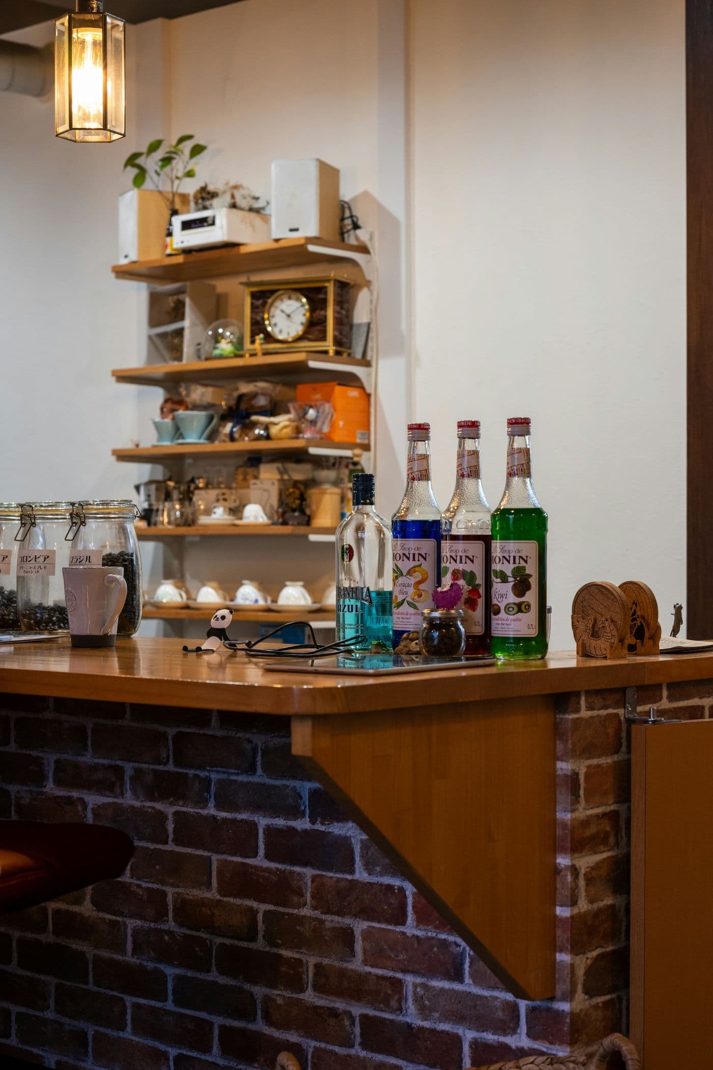 Basement bar with brick wall and shelving