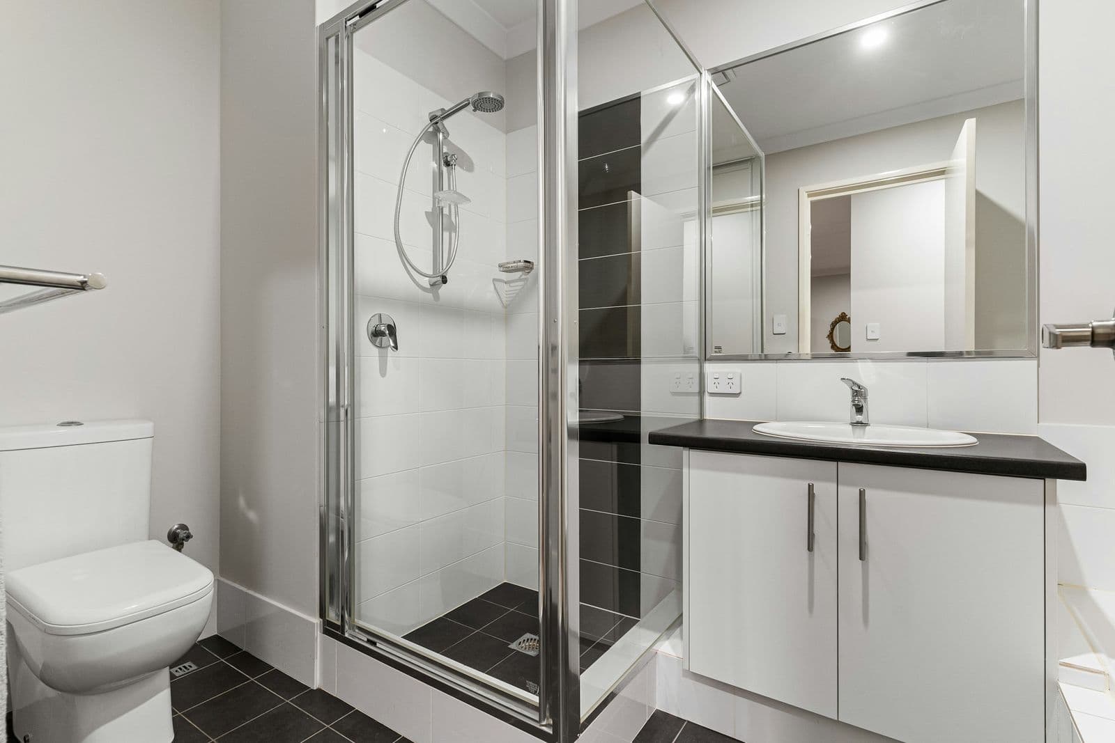 Glass shower enclosure and floating vanity