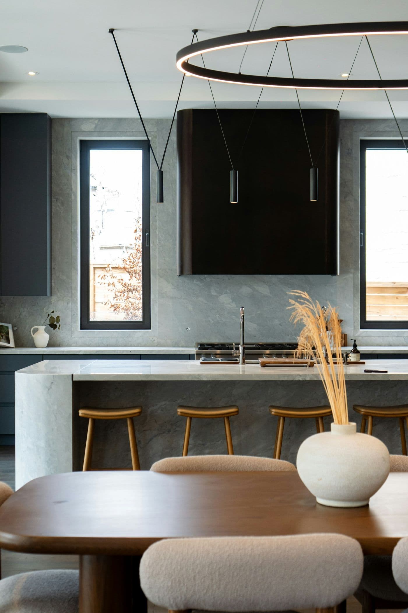 Dark cabinetry with a sculptural pendant