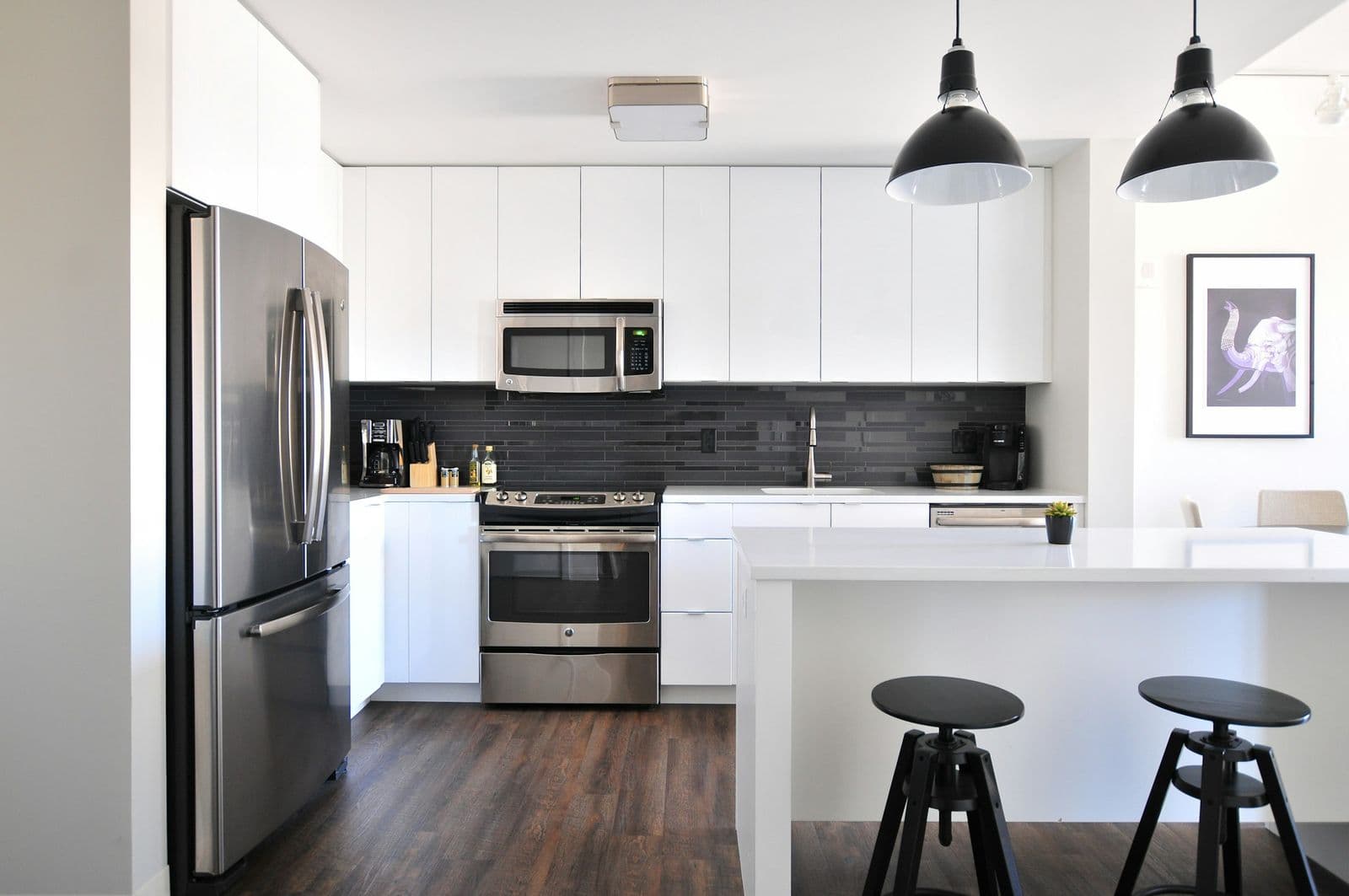 Kitchen with stainless refrigerator and pendant lights