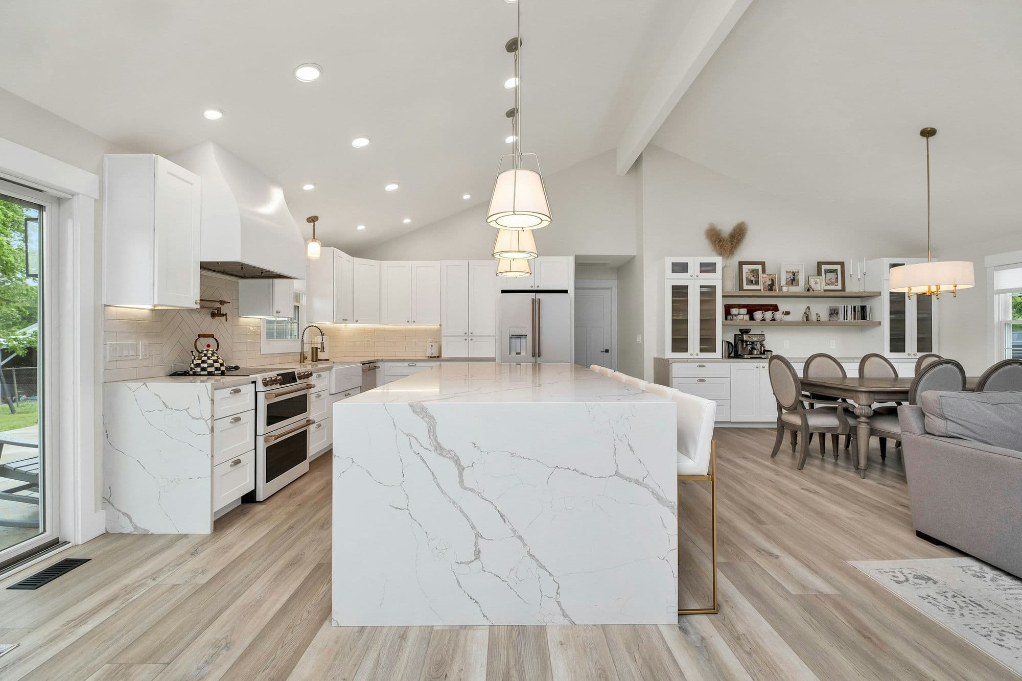 Bright kitchen with a waterfall quartz island