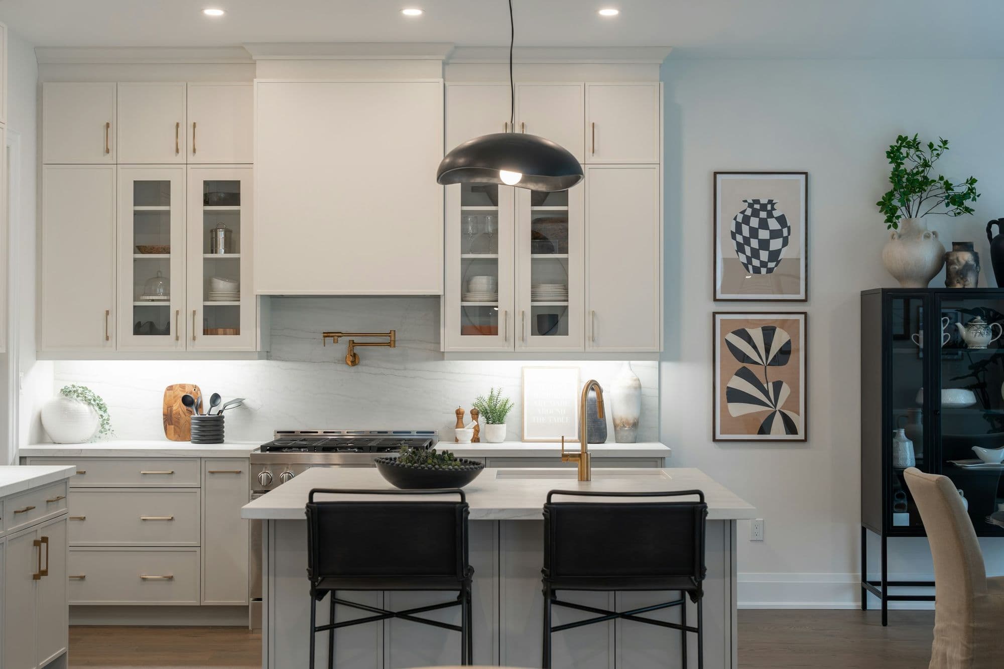 Finished white kitchen with an island and pendant light