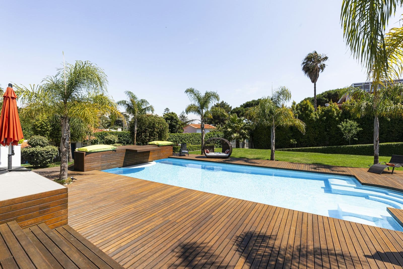 Hardwood pool deck in a sunny backyard